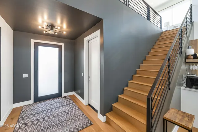 a view of entryway and hall with wooden floor