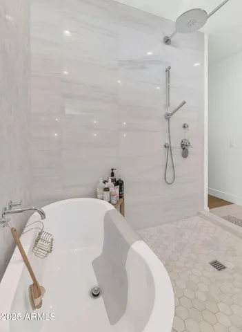 a bathroom with a tub sink and shower
