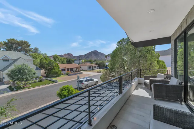 a view of a chairs and table in the balcony