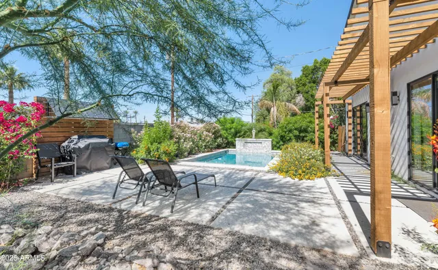 a view of a backyard with sitting area