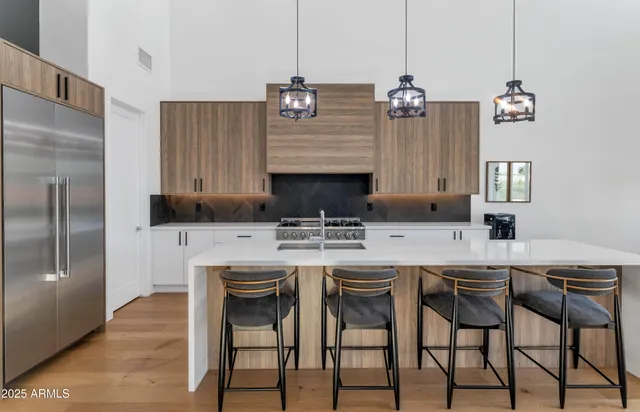 a kitchen with cabinets and chairs