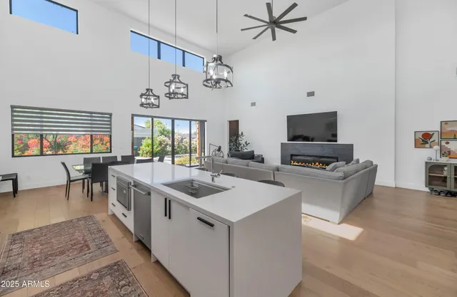 a living room with furniture a flat screen tv and a kitchen view