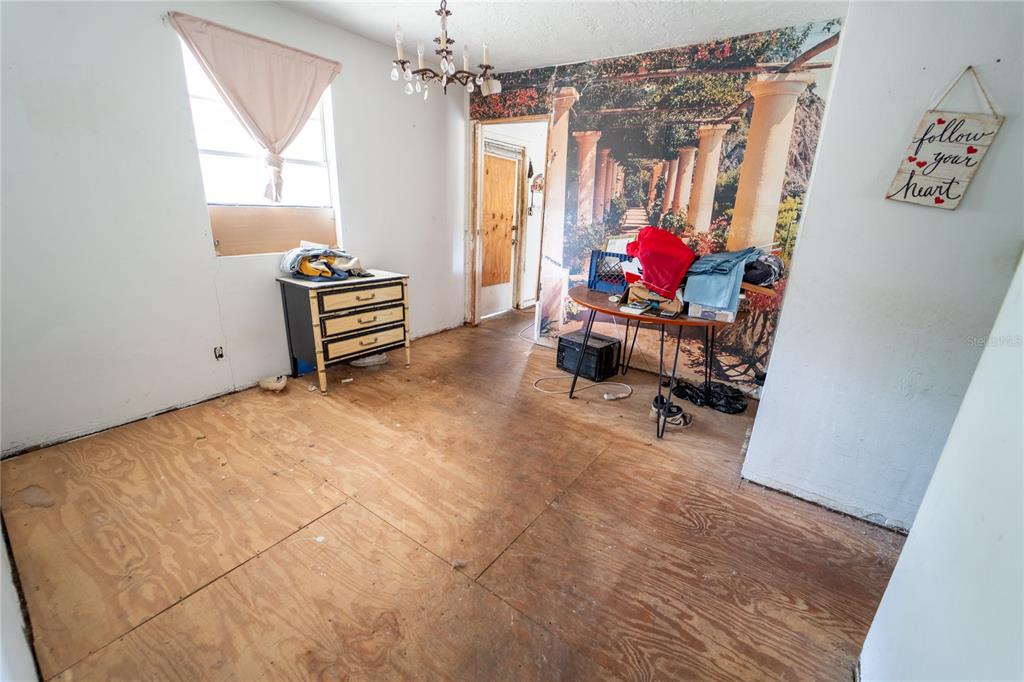 7813 Valrie Lane Riverview, FL 33569 - Photo 16 of 48 a living room with furniture and a chandelier