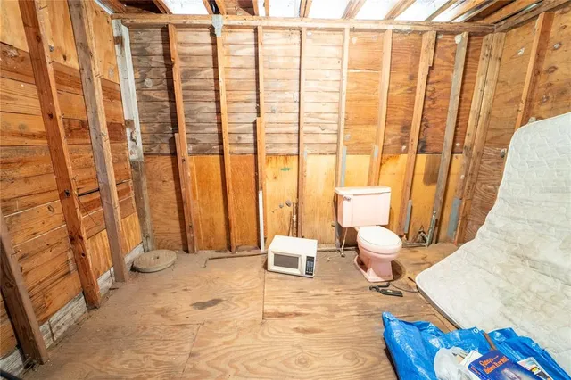 a view of a hallway with furniture and a window