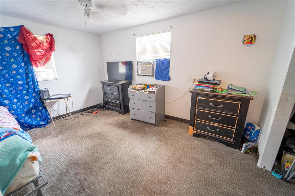 7813 Valrie Lane Riverview, FL 33569 - Photo 22 of 48 a view of a bedroom with baby crib and cabinet