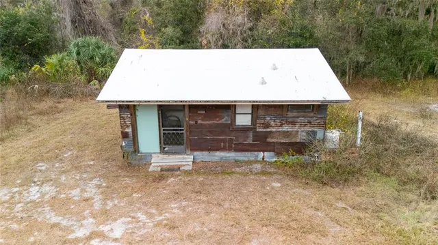 a backyard of a house with table and chairs