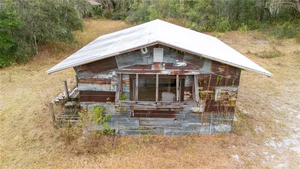a aerial view of a house with table and chairs
