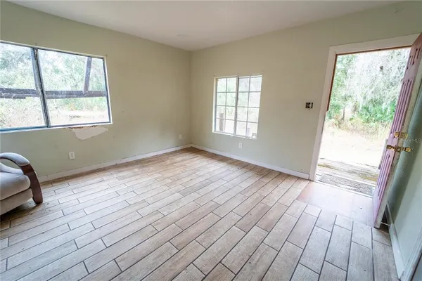 a bedroom with furniture and wooden floor