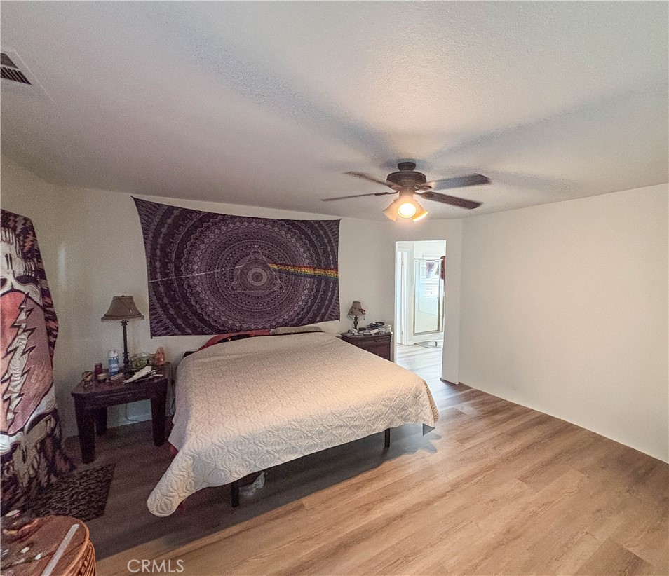 29120 Turtle Rock Court Menifee, CA 92587 - Photo 19 of 40 a bedroom with a bed and a chandelier