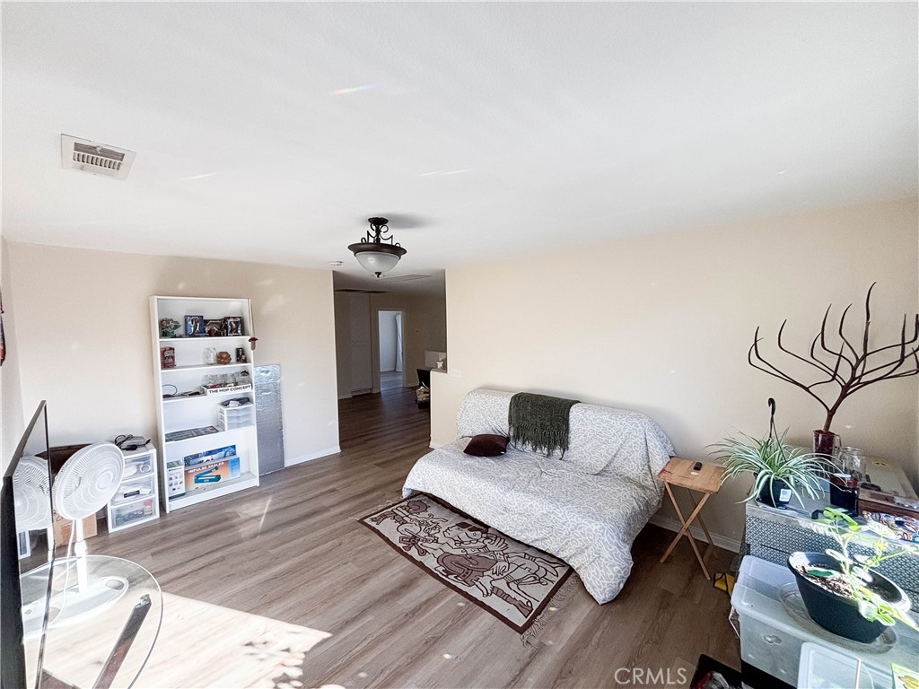 29120 Turtle Rock Court Menifee, CA 92587 - Photo 26 of 40 a bedroom with a bed and wooden floor