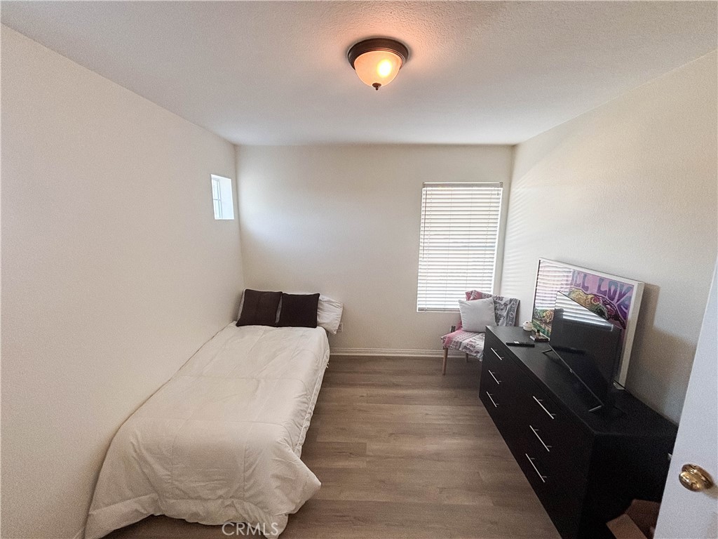 29120 Turtle Rock Court Menifee, CA 92587 - Photo 30 of 40 a bedroom with a bed and wooden floor