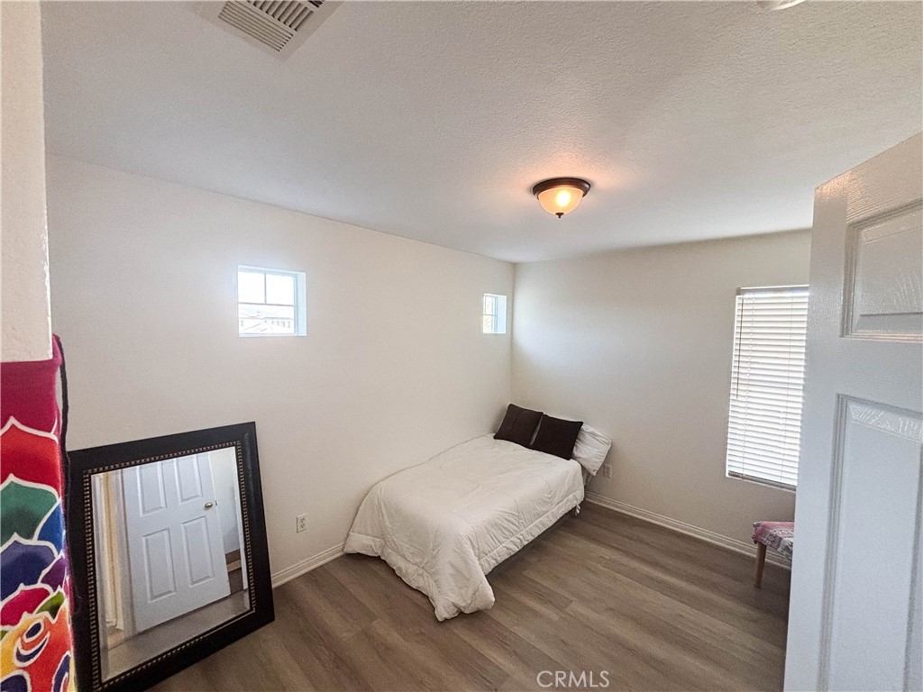 29120 Turtle Rock Court Menifee, CA 92587 - Photo 31 of 40 a bed sitting in a bedroom next to a window
