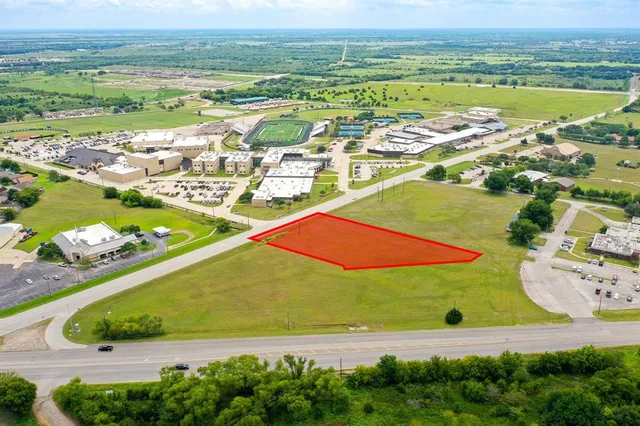 an aerial view of ocean and residential houses with outdoor space