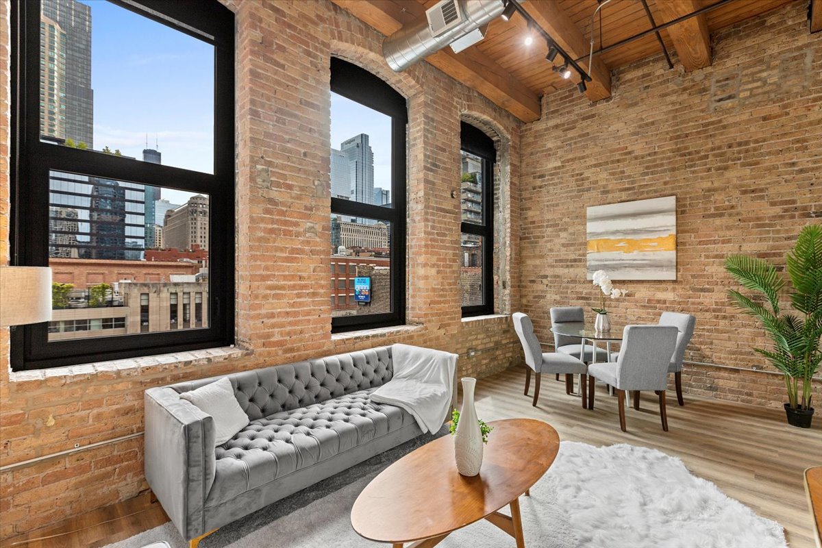 153 West Ohio Street, Unit 403 Chicago, IL 60654 - Photo 3 of 15 a view of a patio with couches and potted plants