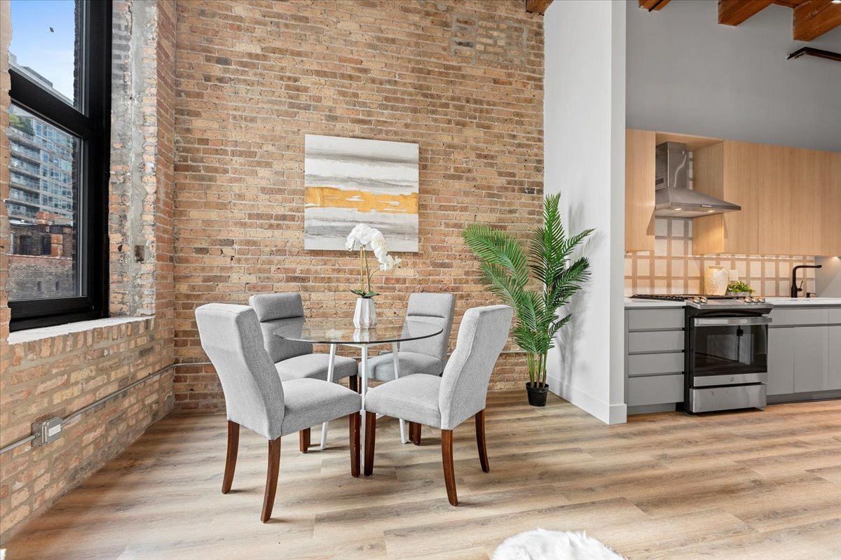 153 West Ohio Street, Unit 403 Chicago, IL 60654 - Photo 4 of 15 a view of a dining room with furniture and wooden floor