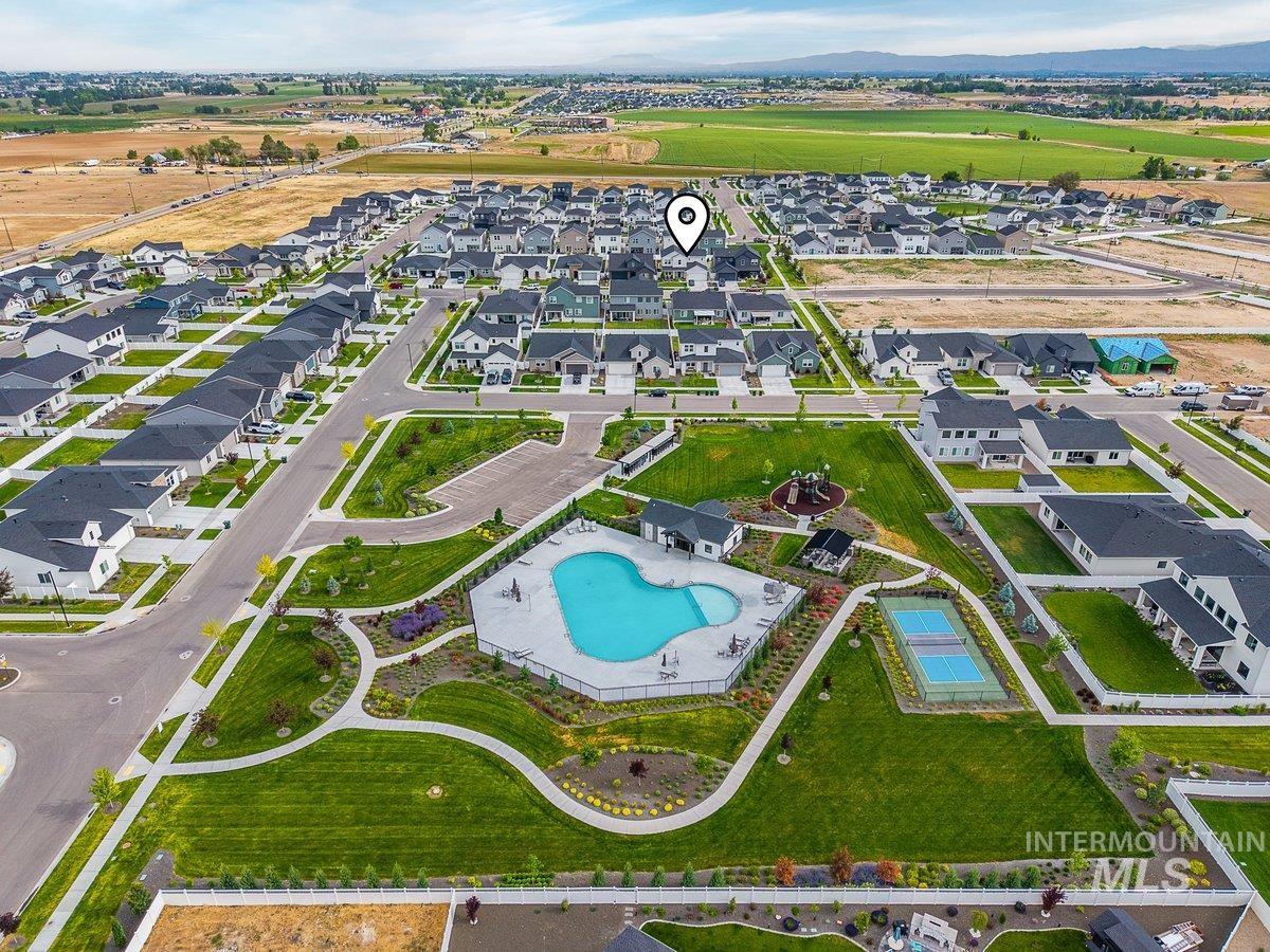 1380 West Chilitna Street Meridian, ID 83642 - Photo 47 of 50 Aerial view of a contemporary neighborhood featuring a community swimming pool, tennis courts, and landscaped green spaces
