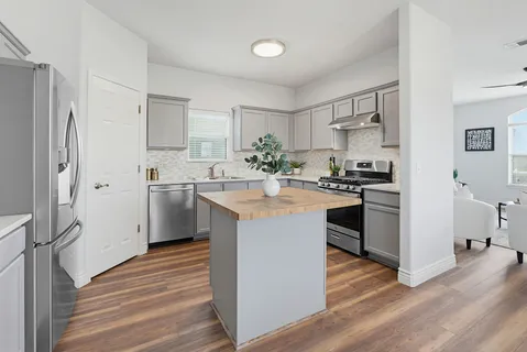 a kitchen with a sink stove and cabinets