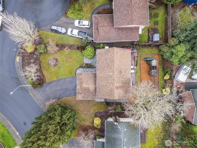 an aerial view of a house with a yard