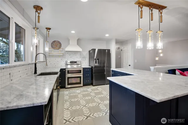 a kitchen with a refrigerator a sink and a stove