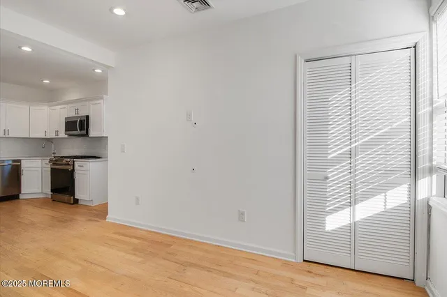 a view of kitchen with wooden floor and electronic appliances