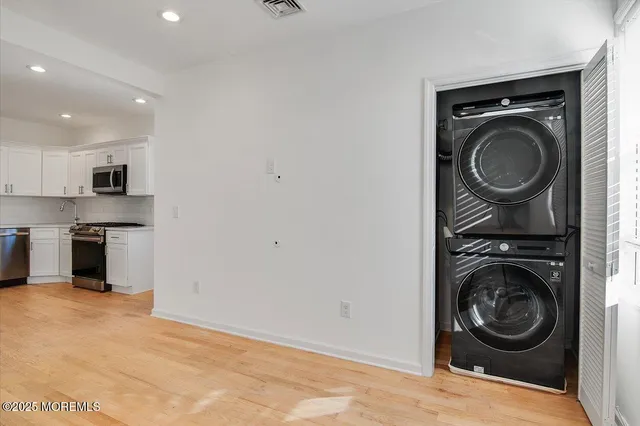 a view of a kitchen with a washer and dryer