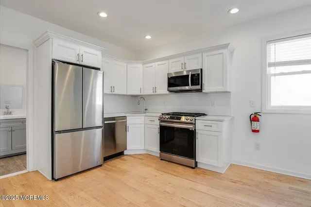 a kitchen with a refrigerator stove and microwave