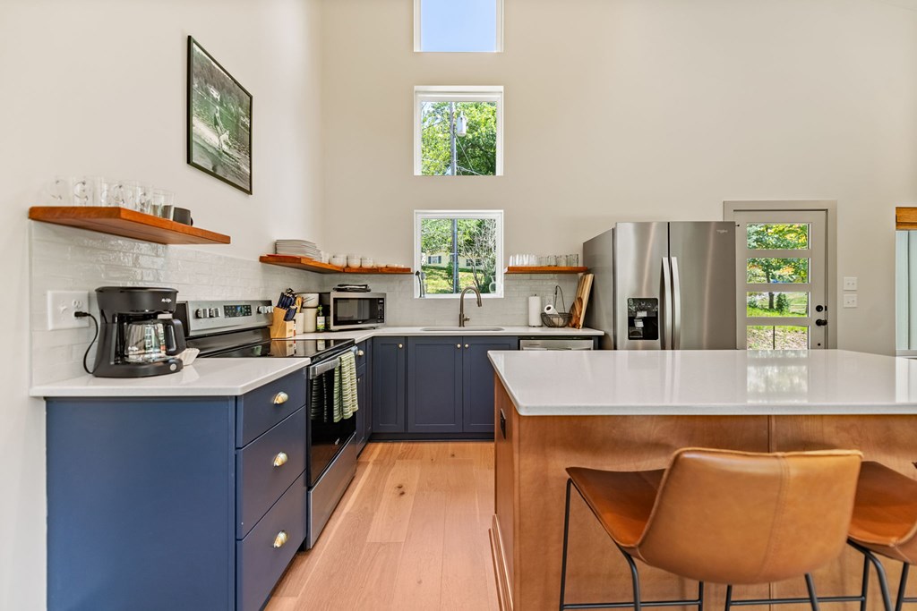 82 Circle Drive Morganton, GA 30560 - Photo 11 of 37 a kitchen with stainless steel appliances granite countertop a stove a sink a refrigerator and a refrigerator