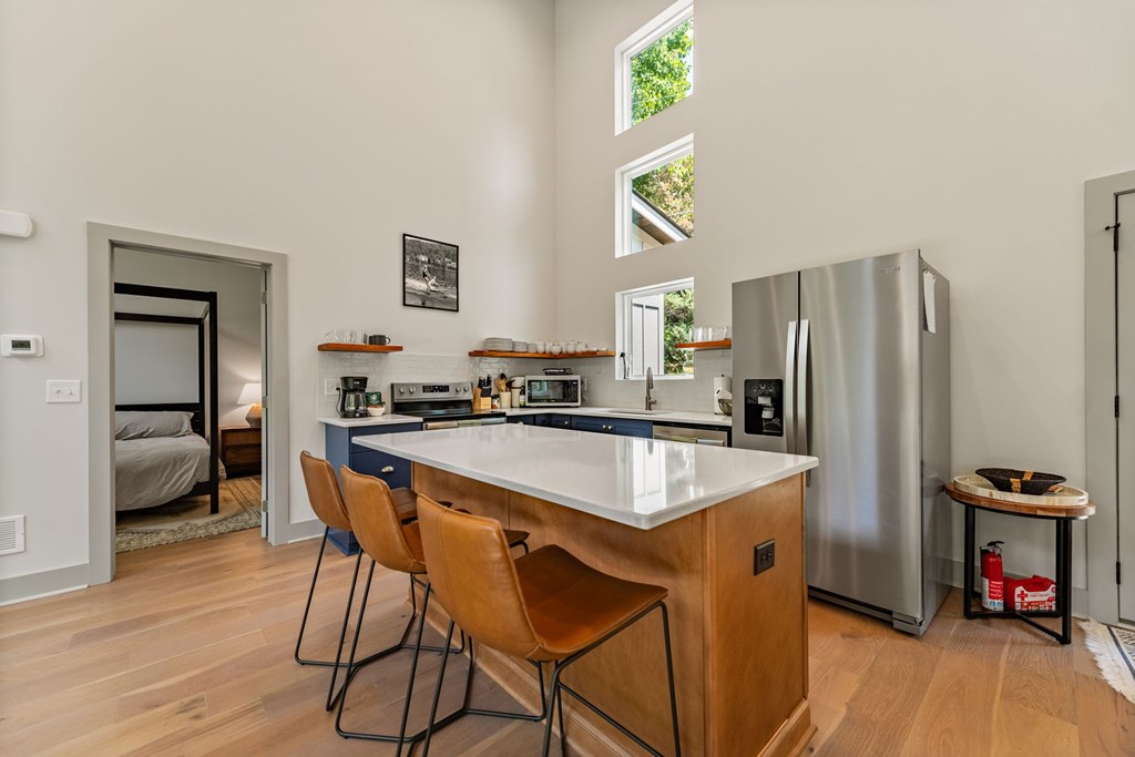 82 Circle Drive Morganton, GA 30560 - Photo 12 of 37 a kitchen with stainless steel appliances granite countertop a refrigerator a stove a sink and a dining table with wooden floor