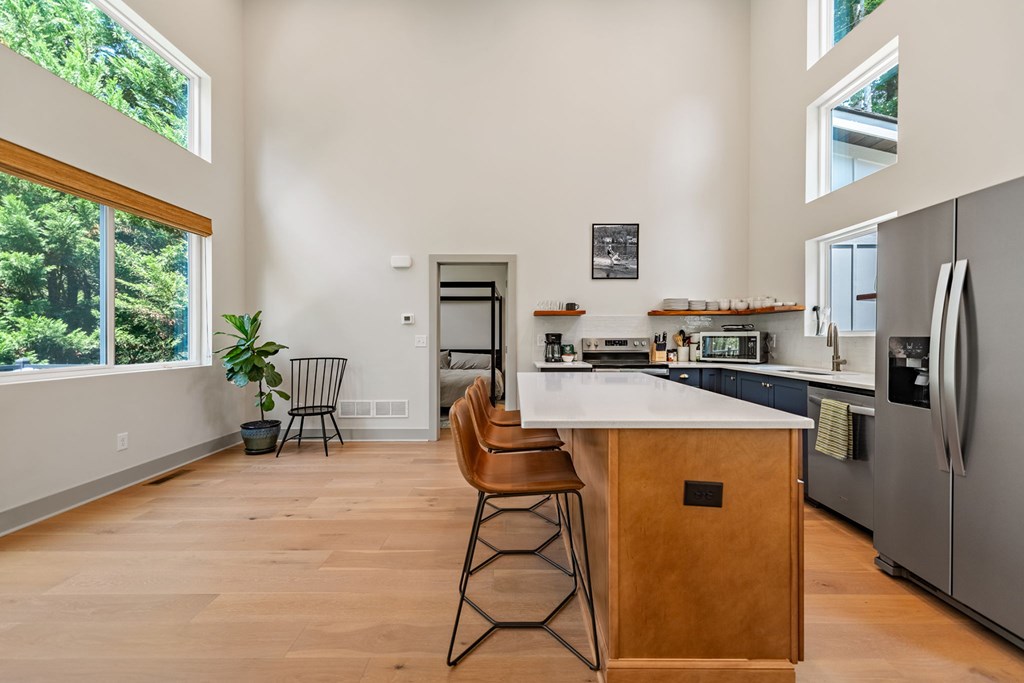 82 Circle Drive Morganton, GA 30560 - Photo 17 of 37 a kitchen with stainless steel appliances kitchen island granite countertop a refrigerator a stove a sink dishwasher and white cabinets with wooden floor