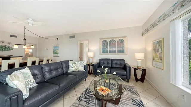 a living room with furniture fireplace and a window