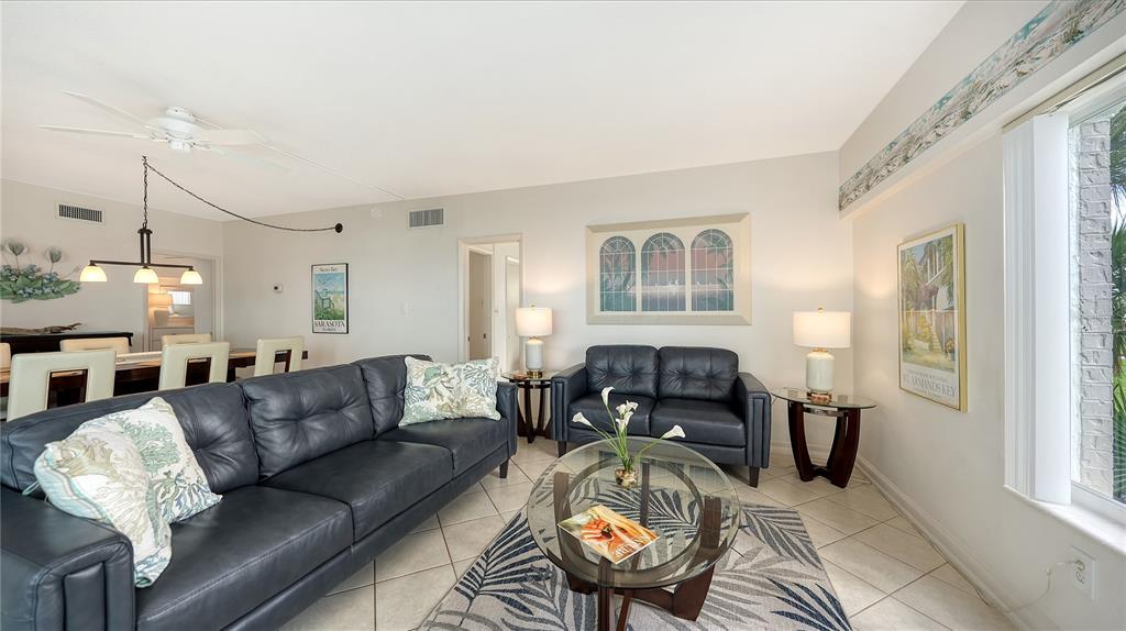 6144 Midnight Pass Road, Unit 2N Sarasota, FL 34242 - Photo 12 of 53 a living room with furniture fireplace and a window