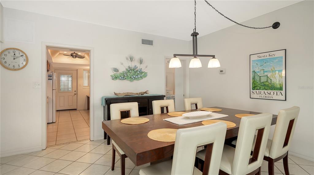 6144 Midnight Pass Road, Unit 2N Sarasota, FL 34242 - Photo 16 of 53 a dining room with furniture and window