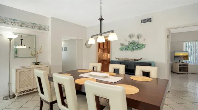 a dining room with furniture and a mirror