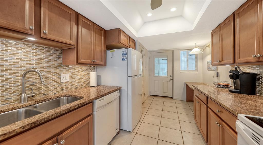 6144 Midnight Pass Road, Unit 2N Sarasota, FL 34242 - Photo 20 of 53 a kitchen with granite countertop a sink a stove and refrigerator