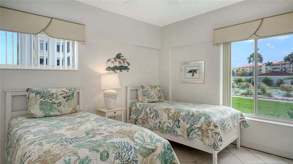 6144 Midnight Pass Road, Unit 2N Sarasota, FL 34242 - Photo 23 of 53 a bedroom with a large bed and a window