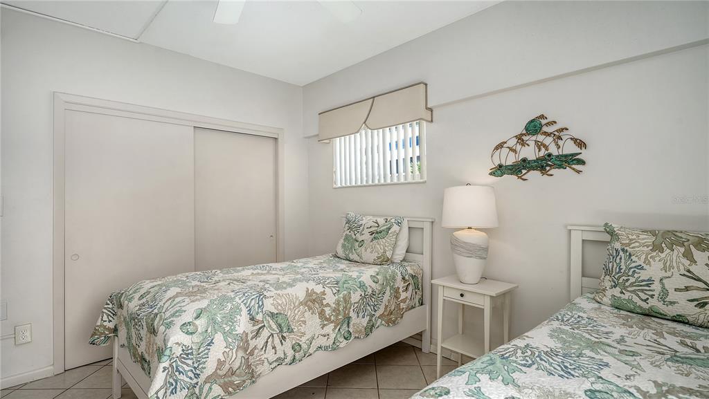6144 Midnight Pass Road, Unit 2N Sarasota, FL 34242 - Photo 24 of 53 a bedroom with a bed and a window
