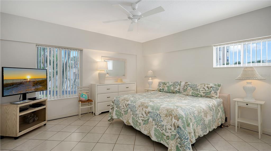 6144 Midnight Pass Road, Unit 2N Sarasota, FL 34242 - Photo 27 of 53 a bedroom with a bed and a flat screen tv