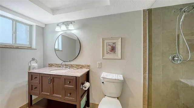 a bathroom with a toilet a sink and a mirror