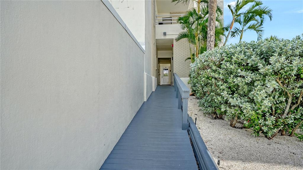 6144 Midnight Pass Road, Unit 2N Sarasota, FL 34242 - Photo 39 of 53 a hallway with flowers