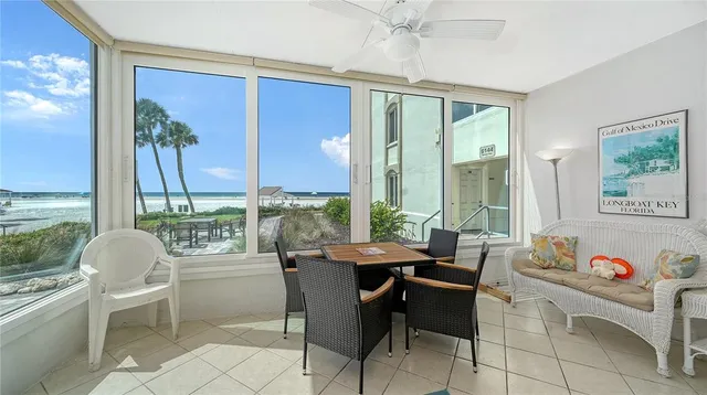 a dining room with furniture a flat screen tv and a large window