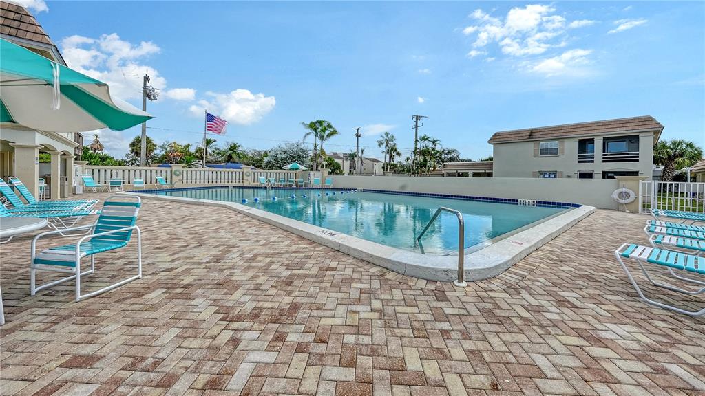 6144 Midnight Pass Road, Unit 2N Sarasota, FL 34242 - Photo 44 of 53 a view of a swimming pool with seating space