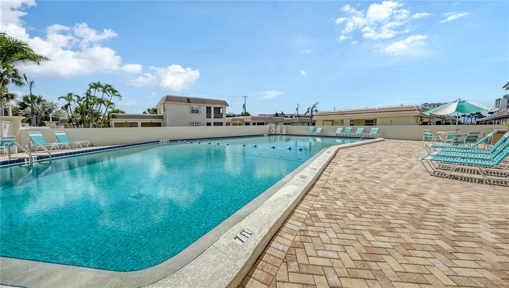 6144 Midnight Pass Road, Unit 2N Sarasota, FL 34242 - Photo 46 of 53 a view of a swimming pool and a yard