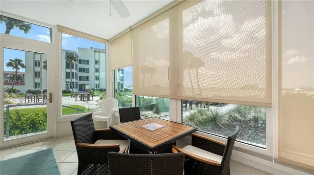 a view of a dining room with furniture large windows and wooden floor