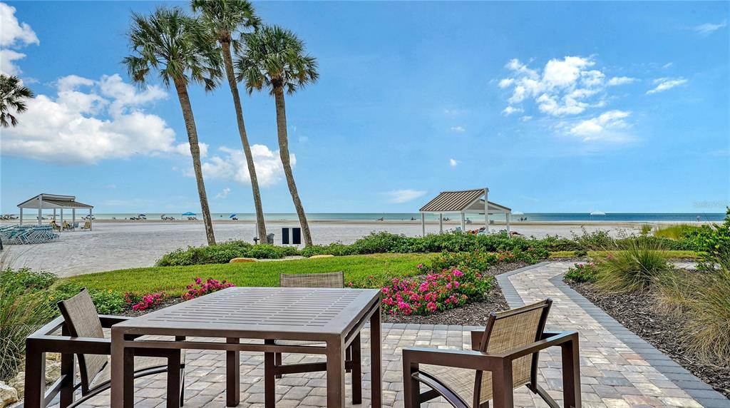 6144 Midnight Pass Road, Unit 2N Sarasota, FL 34242 - Photo 10 of 53 a view of a patio with furniture and a garden