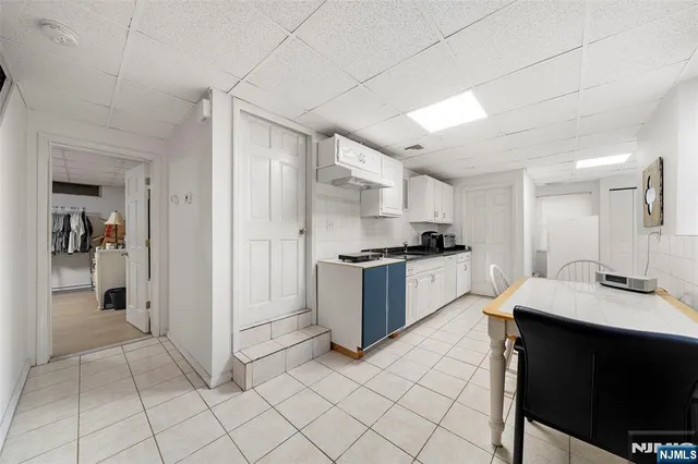 a kitchen with a sink cabinets and refrigerator