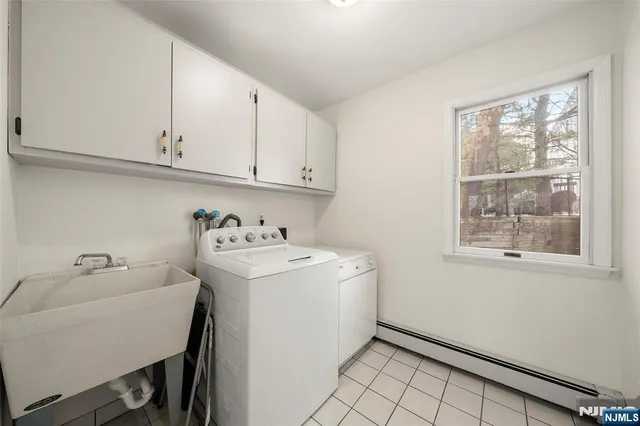 a utility room with sink dryer and washer
