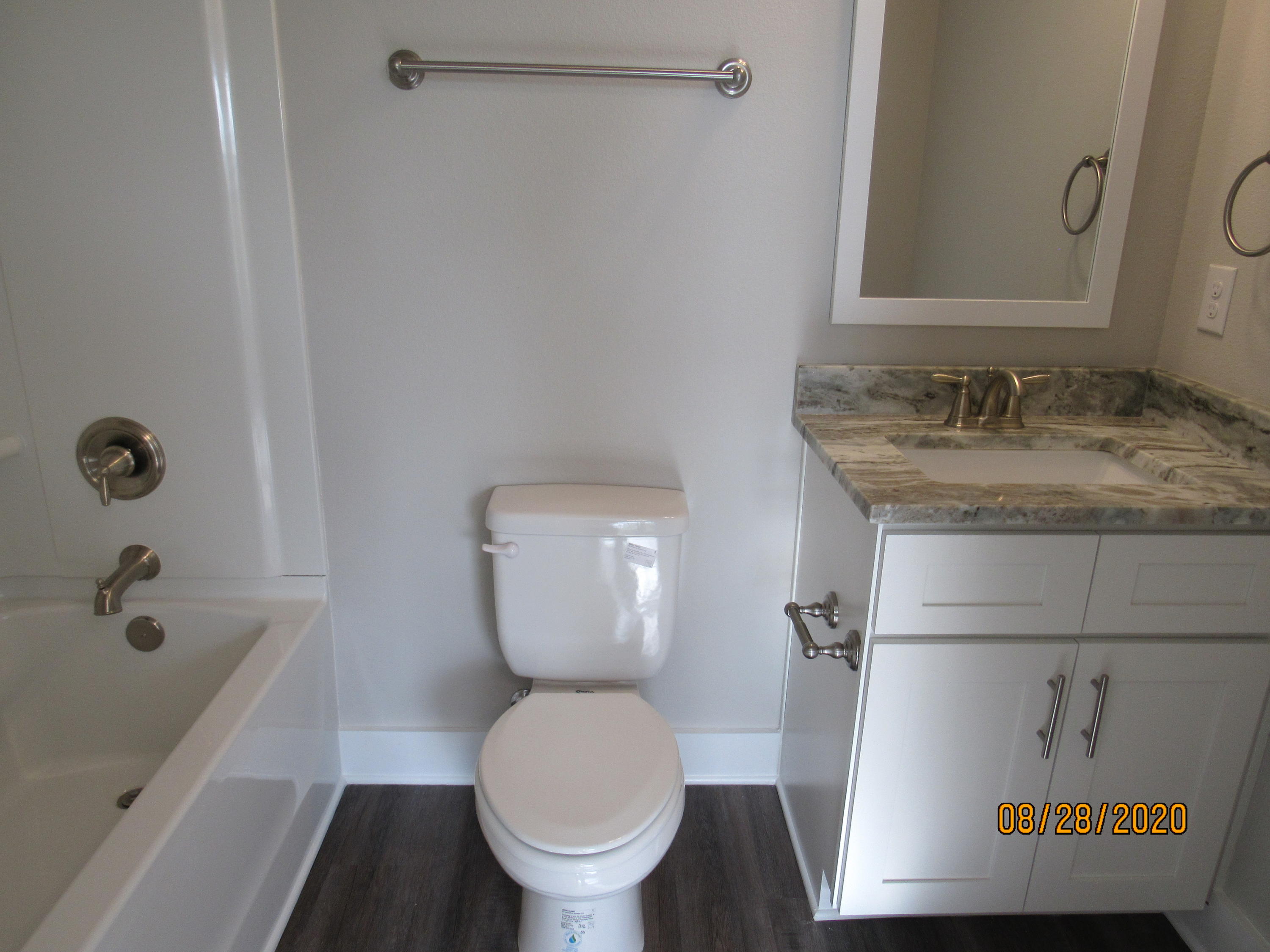 75 South Sand Palm Road Freeport, FL 32439 - Photo 11 of 18 a bathroom with a granite countertop toilet and a sink
