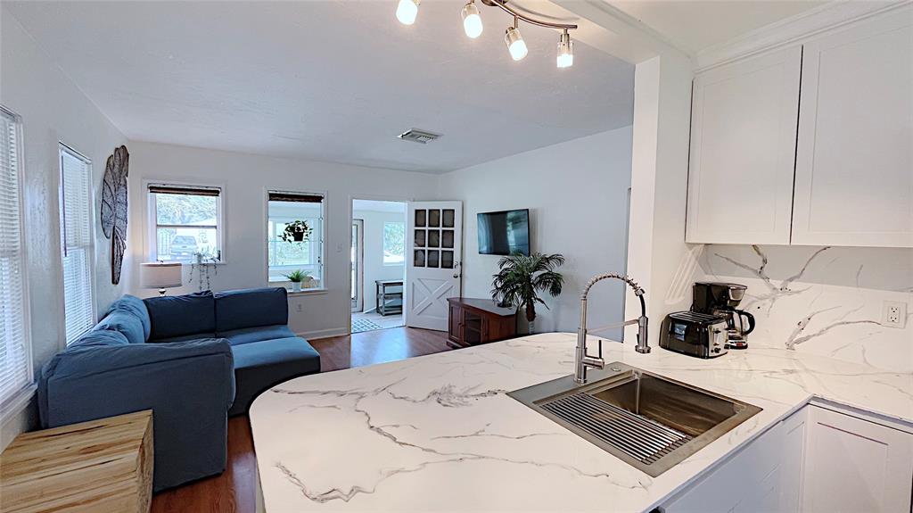 342 Southwest 2nd Avenue Dania Beach, FL 33004 - Photo 18 of 27 a kitchen with a refrigerator a stove a sink and living room view