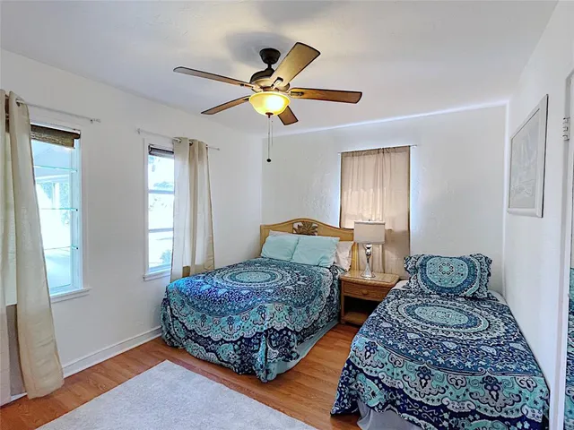 a bedroom with two beds and a window