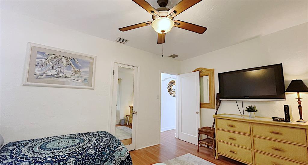 342 Southwest 2nd Avenue Dania Beach, FL 33004 - Photo 23 of 27 a bedroom with furniture and a flat screen tv